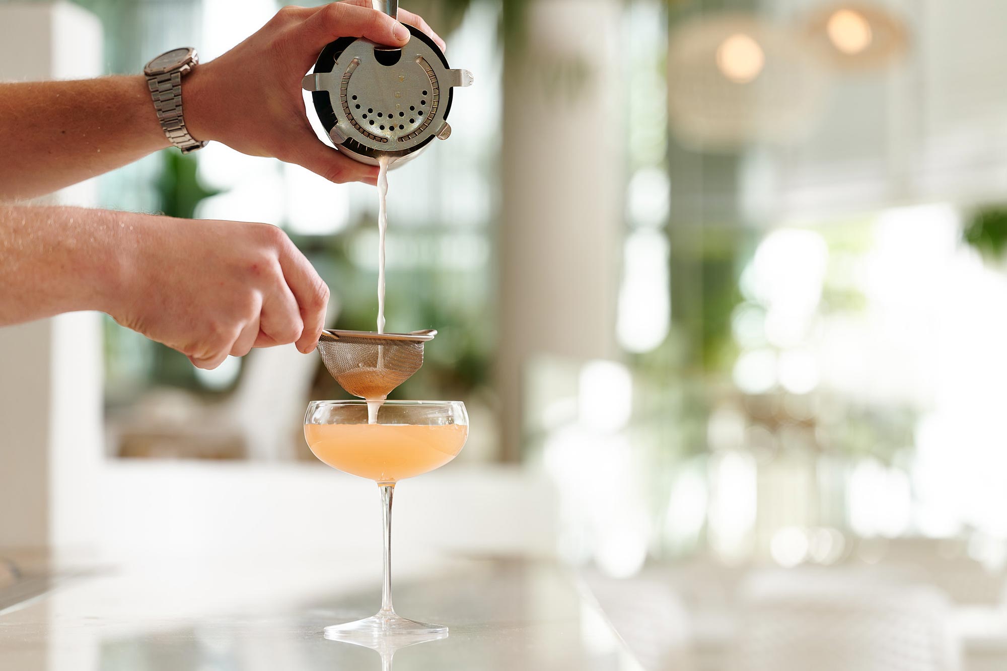 Bartender crafting a cocktail at Noosa Beach House, a top bar destination in Noosa
